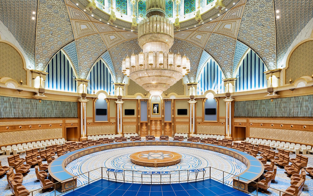 Ornate interior of Qasr Al Watan's grand hall with intricate ceiling and chandelier, Abu Dhabi.