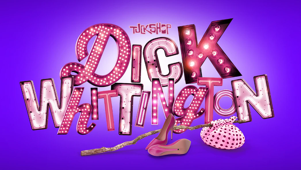 Dick Whittington sign with pink lights, high heels, and polka dot bag on purple background.