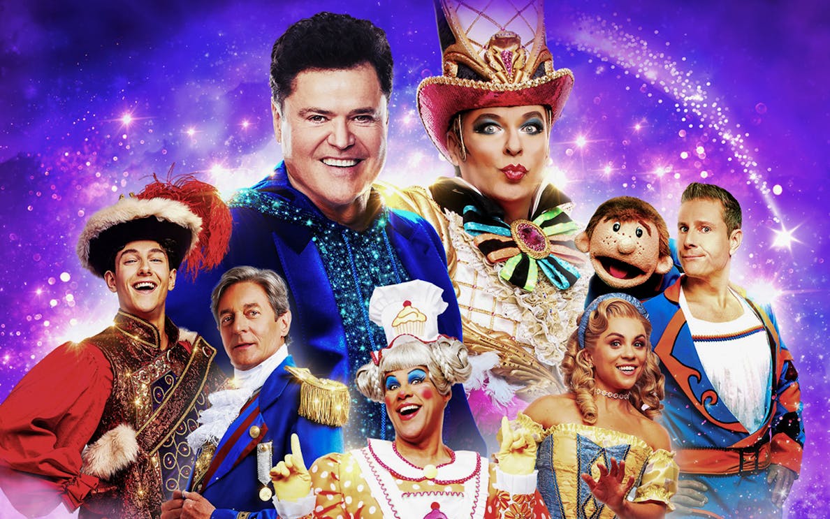 Colorful cast of performers in vibrant costumes for Pantoland show.