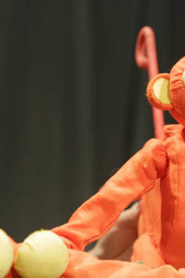 Orange monkey puppet from Five Little Christmas Monkeys show.
