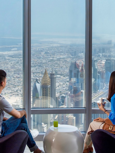 Visitors enjoying the view from Burj Khalifa's observation deck in Dubai.