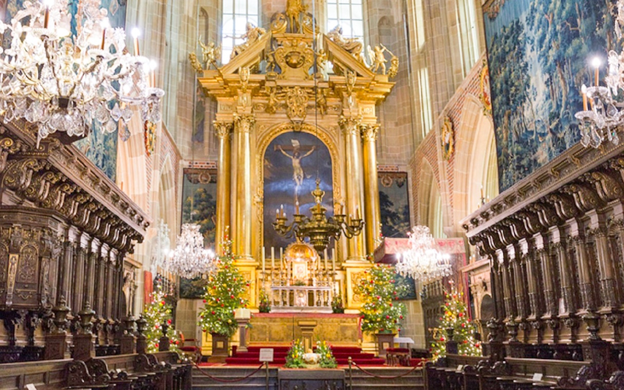 Wawel Cathedral interior with ornate altar and chandeliers, Krakow tour.