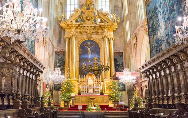 Wawel Cathedral interior with ornate altar and chandeliers, Krakow tour.