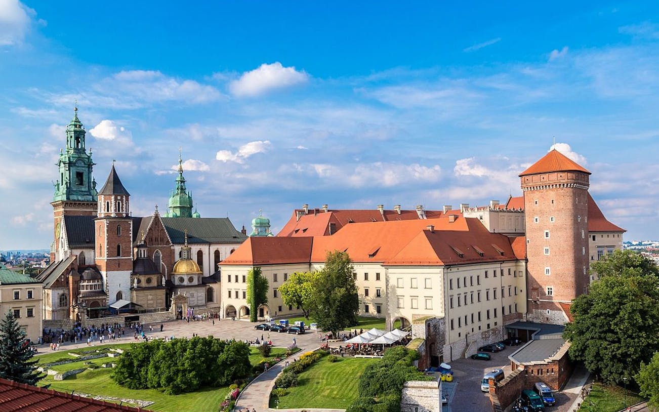Wawel Castle in Krakow with tourists exploring the courtyard and historic architecture.