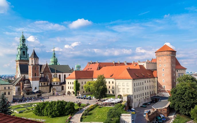 Wawel Castle in Krakow with tourists exploring the courtyard and historic architecture.