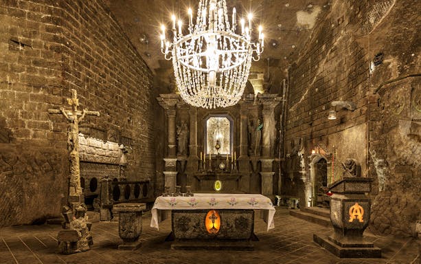 Wieliczka Salt Mine chapel with ornate altar and chandelier in Krakow tour.