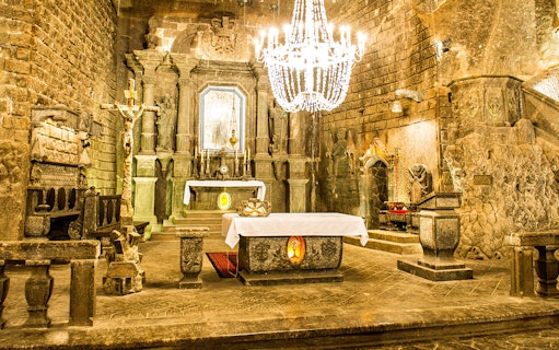 Wieliczka Salt Mine chapel interior with altar and chandelier, Krakow tour.