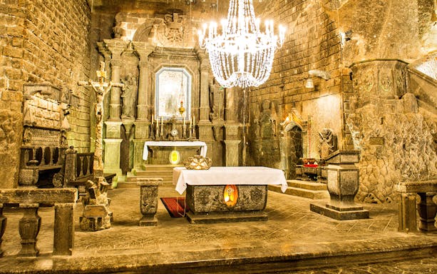 Wieliczka Salt Mine chapel interior with altar and chandelier, Krakow tour.