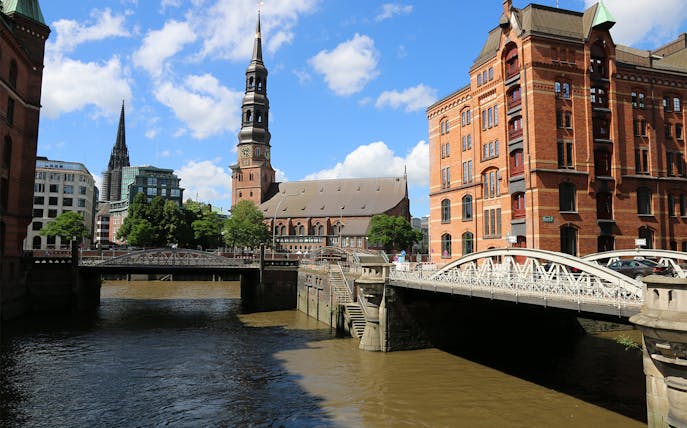 Speicherstadt canal view with St. Katharinen Church, Hamburg.