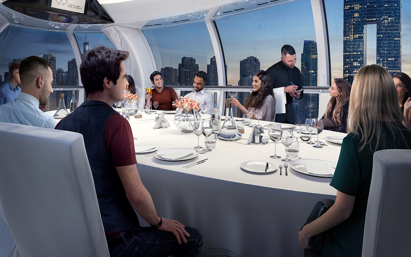 Dining experience inside Ain Dubai capsule with city skyline view.