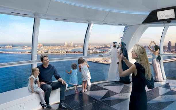 Visitors enjoying panoramic views from Ain Dubai observation cabin.