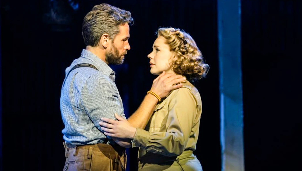 Actors performing a scene from Rodgers & Hammerstein’s South Pacific on stage.