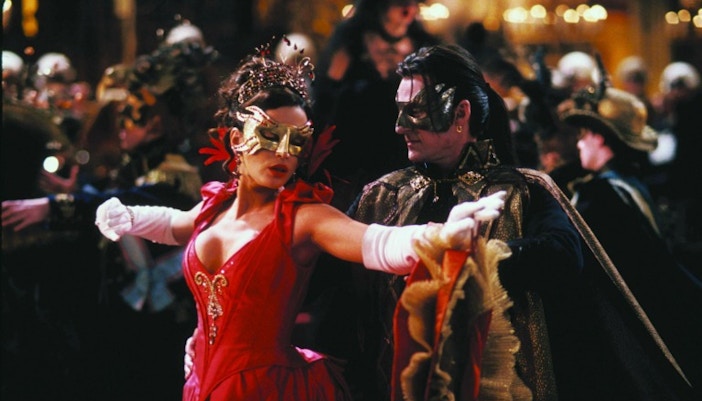 The Palazzo Vendramin-Calergi building on the banks of the Grand Canal in Venice, with a grand masquerade ball setting.