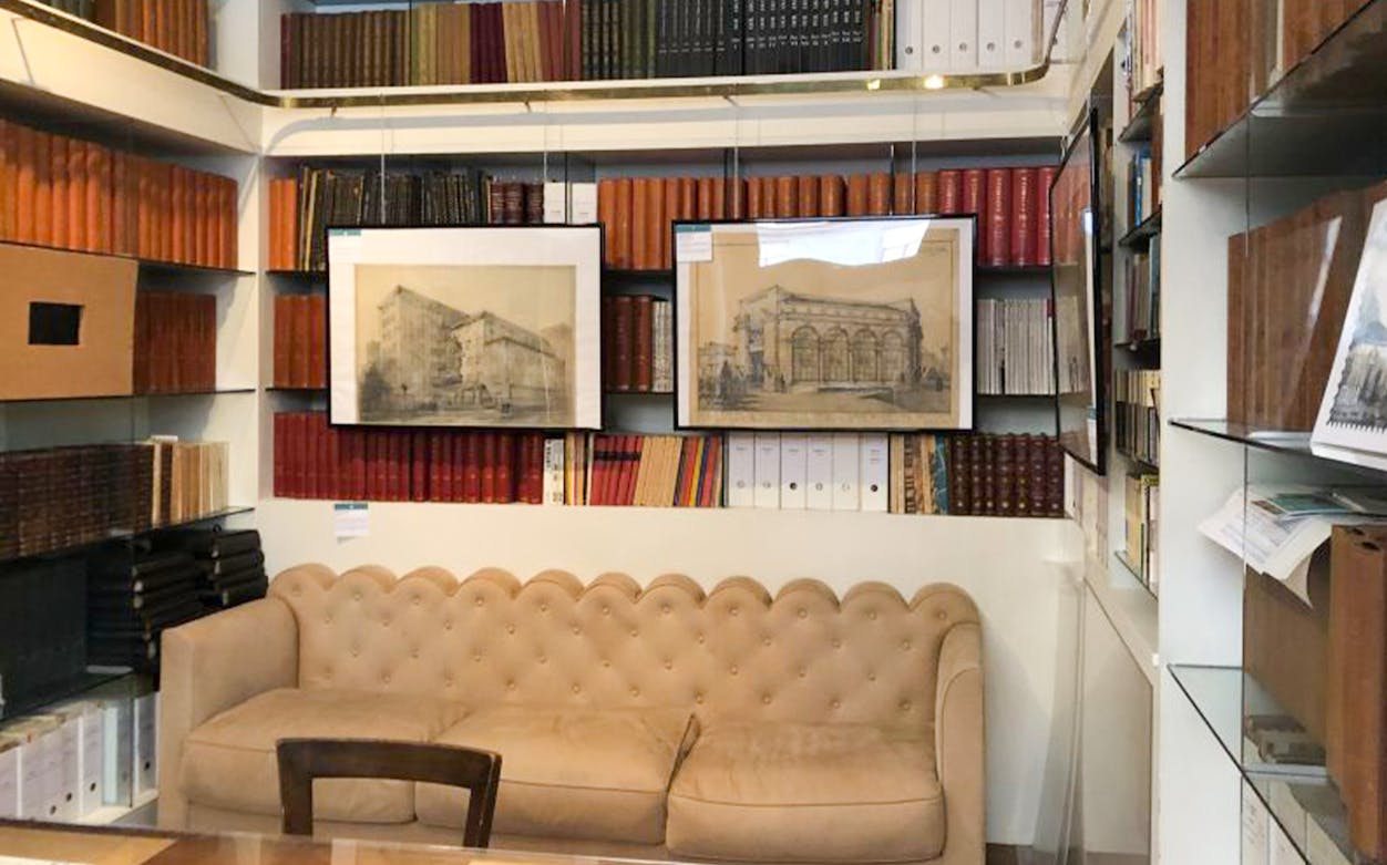 Portaluppi Studio-Museum interior with bookshelves and architectural sketches.
