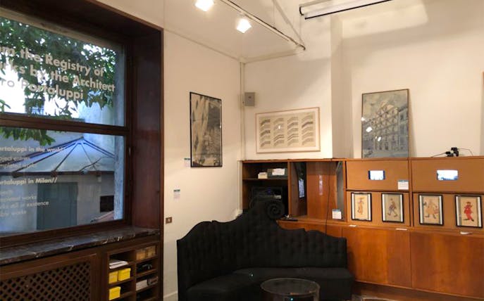 Portaluppi Studio-Museum interior with framed artworks and seating area.