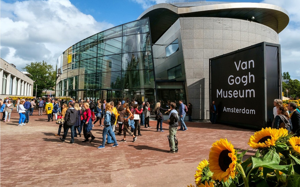 Van Gogh Museum entrance with visitors in Amsterdam.