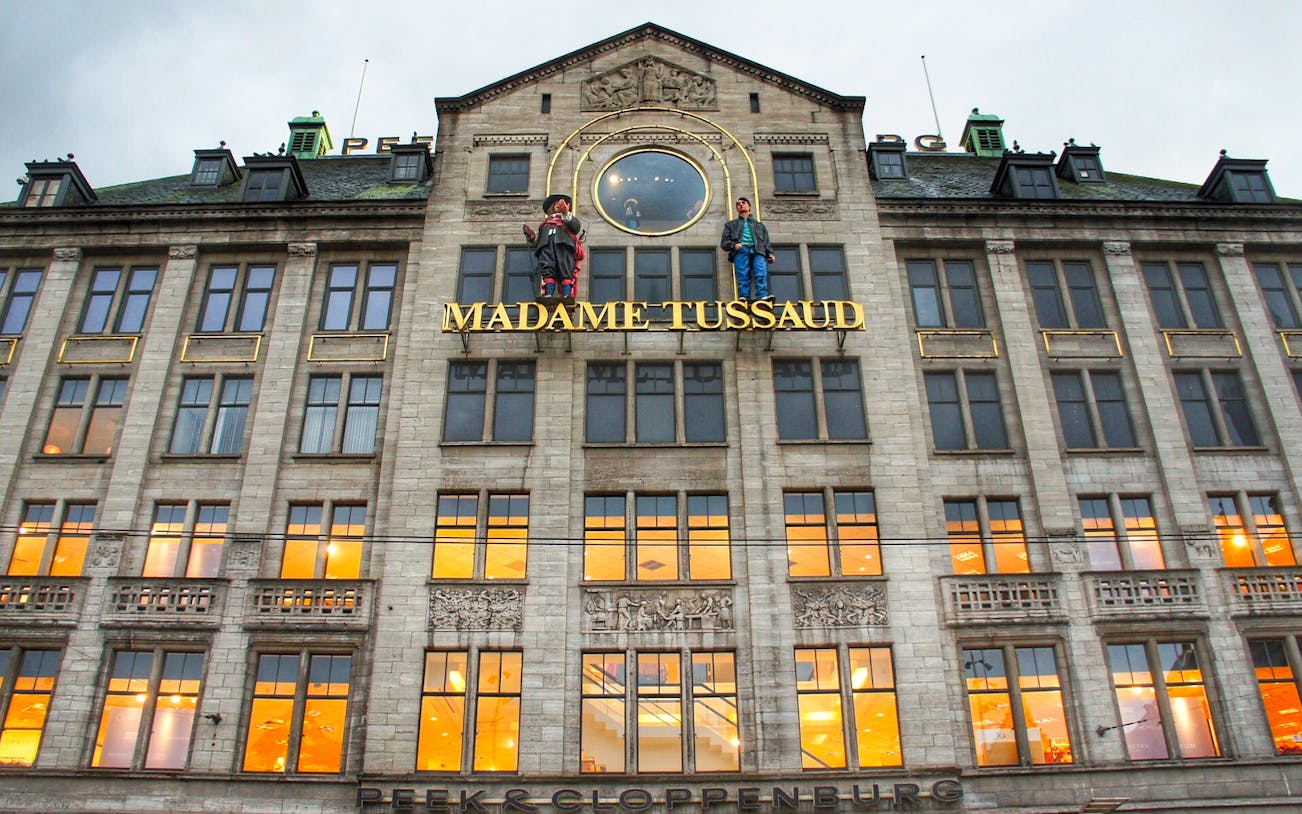 Madame Tussauds building facade in Dam Square, Amsterdam, featured on self-guided audio tour.