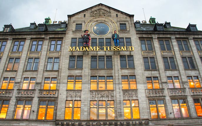Madame Tussauds building facade in Dam Square, Amsterdam, featured on self-guided audio tour.