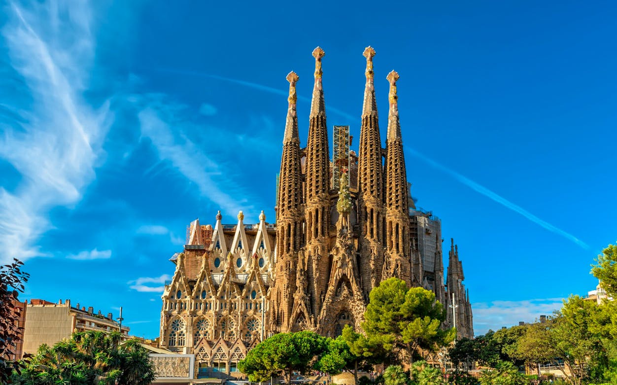 Sagrada Familia basilica in Barcelona under a clear blue sky.