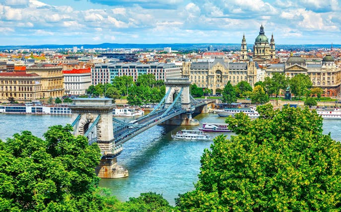 Chain Bridge over Danube River in Budapest with cityscape background.