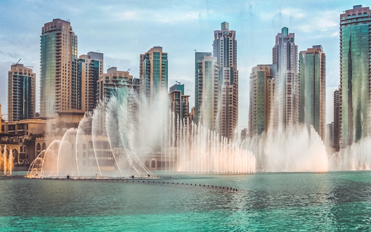 Dubai Fountain show with skyscrapers in the background, part of a self-guided audio tour.