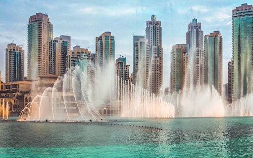Dubai Fountain show with skyscrapers in the background, part of a self-guided audio tour.