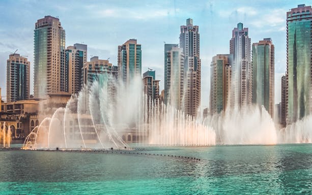 Dubai Fountain show with skyscrapers in the background, part of a self-guided audio tour.