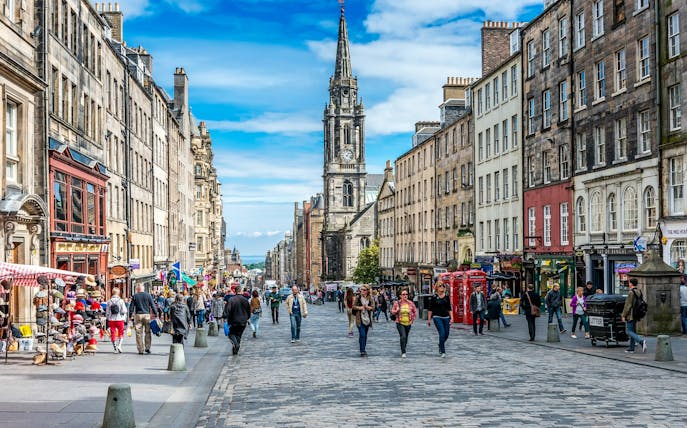Royal Mile street view in Edinburgh with St. Giles' Cathedral in the background.