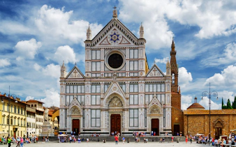 Basilica of Santa Croce in Florence with tourists in the foreground.