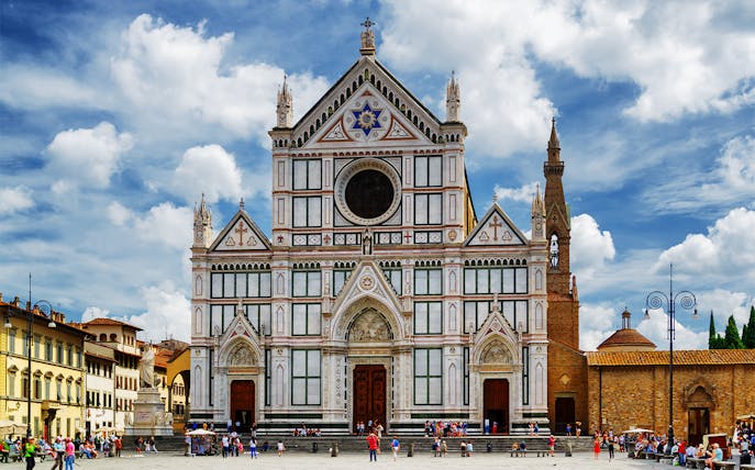 Basilica of Santa Croce in Florence with tourists in the foreground.