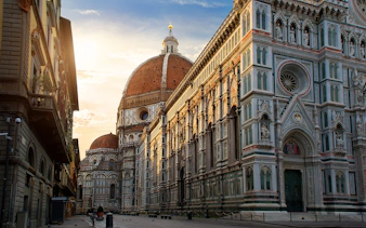 Florence Cathedral exterior with dome at sunset, part of self-guided audio tour.