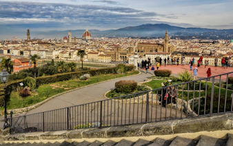 Florence cityscape view from Piazzale Michelangelo with tourists exploring.