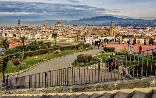 Florence cityscape view from Piazzale Michelangelo with tourists exploring.