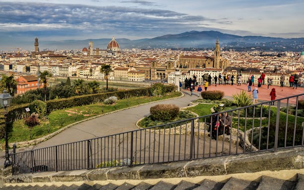 Florence cityscape view from Piazzale Michelangelo with tourists exploring.