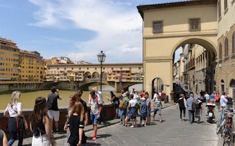 Tourists near Ponte Vecchio in Florence during a self-guided audio tour.