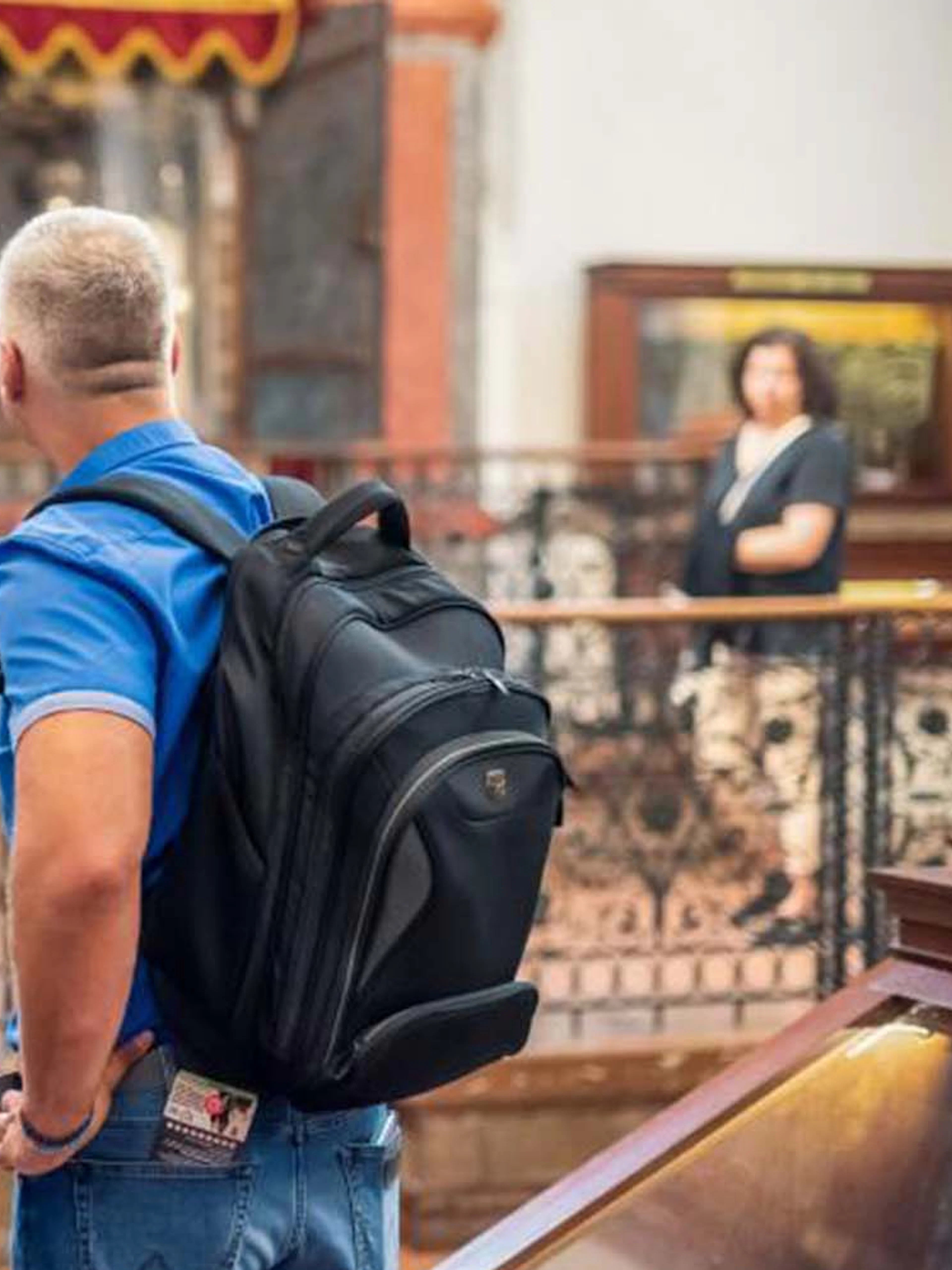Visitors exploring a historic synagogue in Prague's Jewish Quarter.
