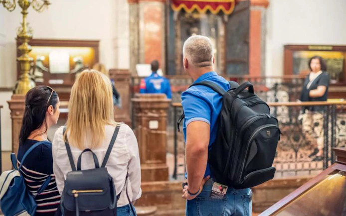 Visitors exploring a historic synagogue in Prague's Jewish Quarter.