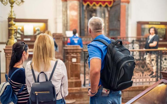 Visitors exploring a historic synagogue in Prague's Jewish Quarter.
