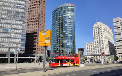 Red double-decker bus on Berlin's Potsdamer Platz during 24-hour hop-on hop-off tour.