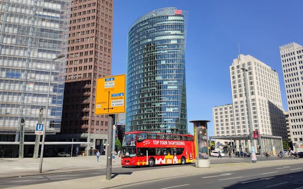Red double-decker bus on Berlin's Potsdamer Platz during 24-hour hop-on hop-off tour.
