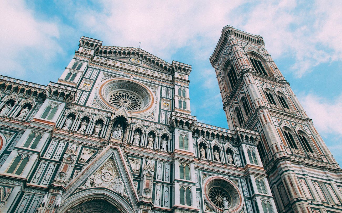 Santa Maria del Fiore facade and bell tower in Florence, Italy, viewed from below.