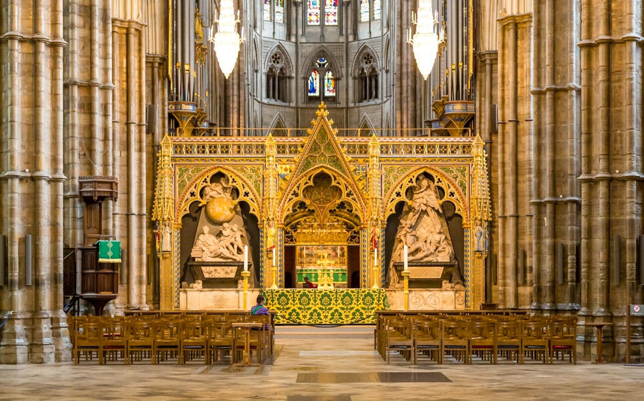 Westminster Abbey interior with ornate altar and historic sculptures, London.