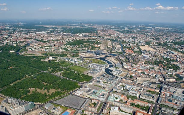Aerial view of Berlin skyline featuring the Spree River and cityscape during Rundflug tour.