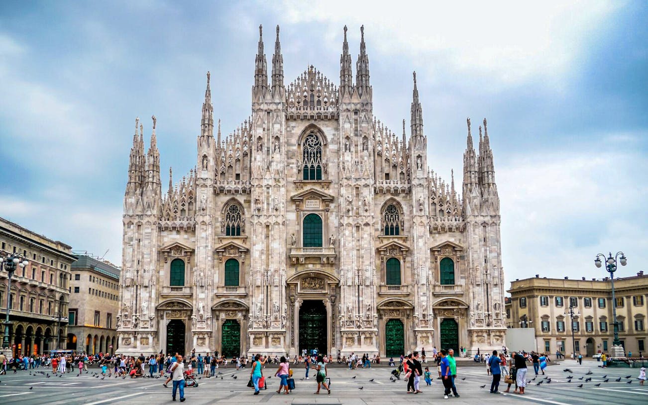 Milan Cathedral facade with tourists in Piazza del Duomo during self-guided audio tour.