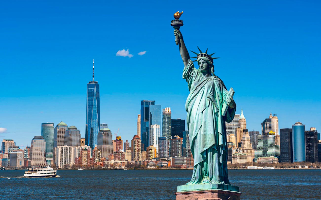 Statue of Liberty with New York City skyline in the background.