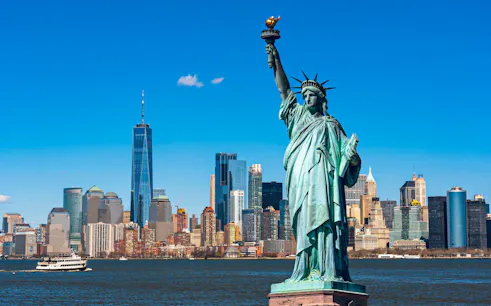Statue of Liberty with New York City skyline in the background.