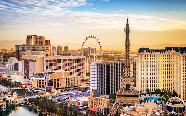 Las Vegas skyline with Eiffel Tower replica and High Roller observation wheel.