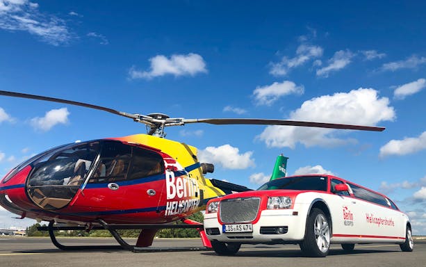 Helicopter and limousine for Rundflug Berlin City tour on a sunny day.
