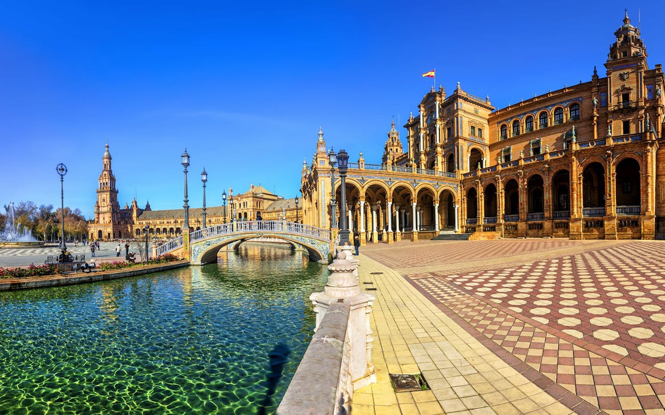 Plaza de España in Seville with canal and arched bridge, part of self-guided audio tour.