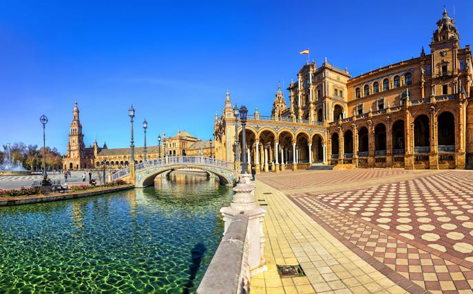 Plaza de España in Seville with canal and arched bridge, part of self-guided audio tour.
